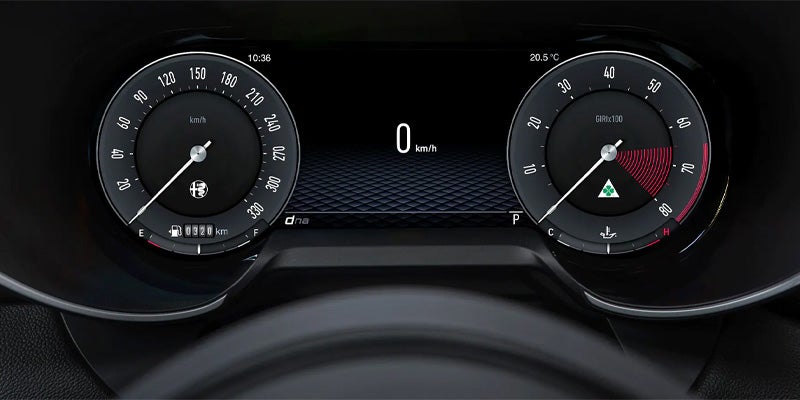 An Alfa Romeo digital instrument cluster displaying speed and RPM gauges.