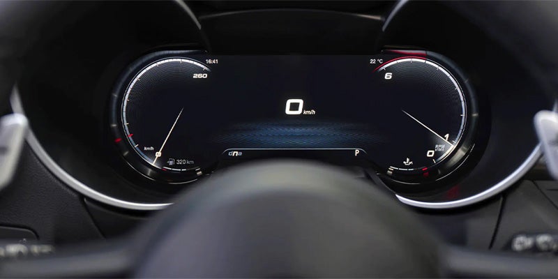 Digital instrument cluster of a modern car showing speed and engine data.