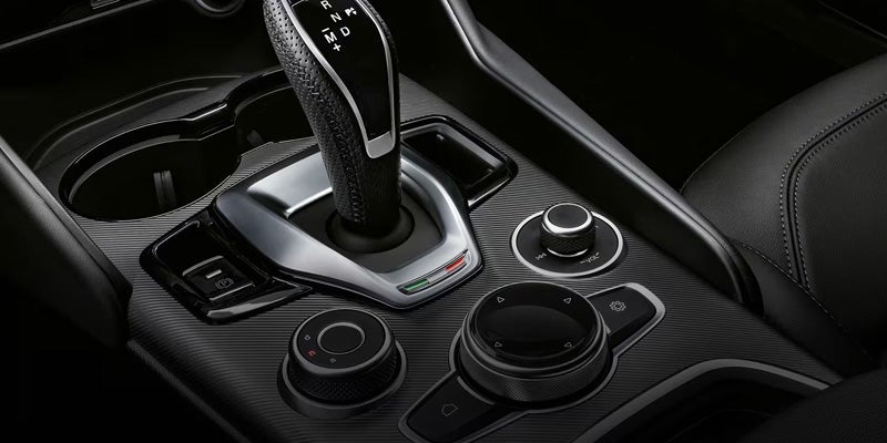 Close-up of the center console, gear shifter, and rotary controllers