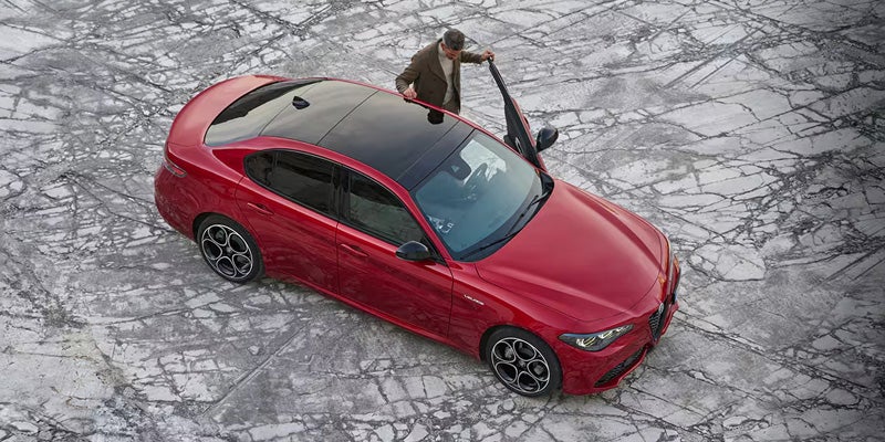 Aerial shot of a red Alfa Romeo Giulia with a black sunroof