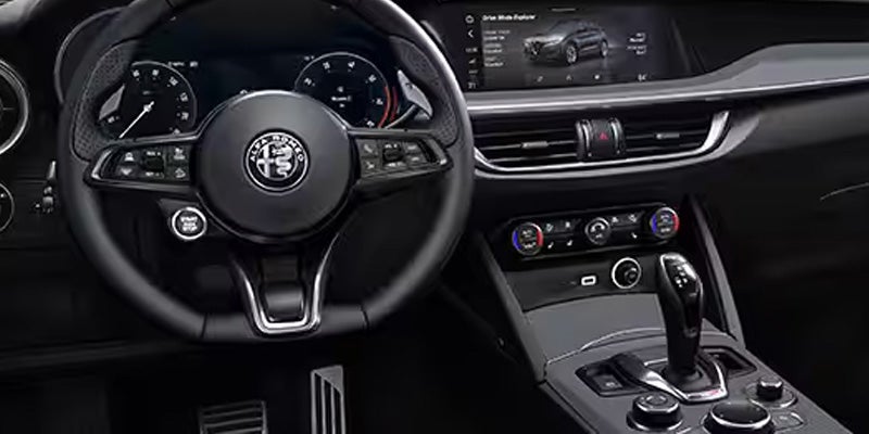 Modern interior of an Alfa Romeo Tonale featuring a leather steering wheel